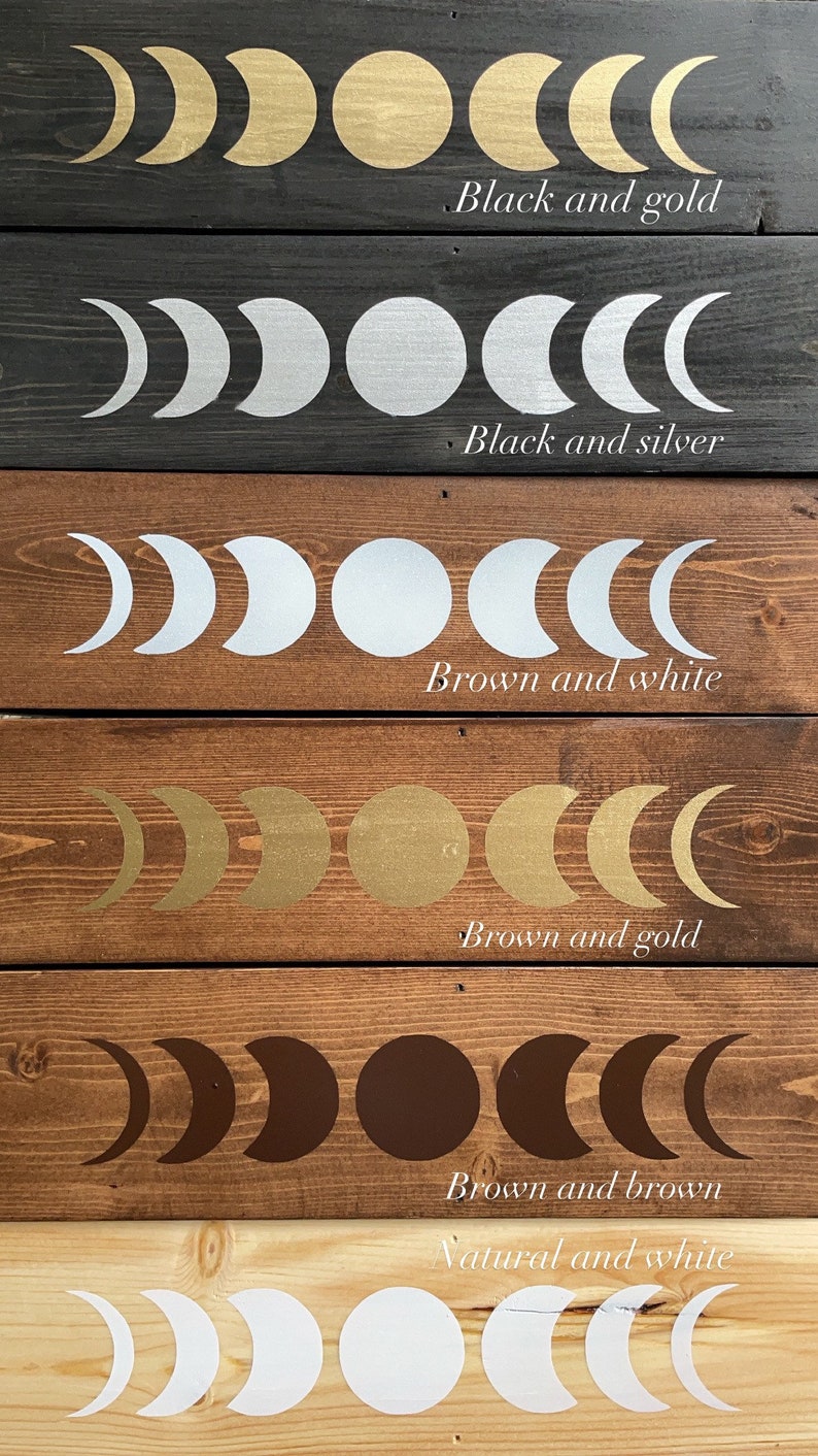May include: Six wooden boards with different colored backgrounds, each featuring a moon phase design in a contrasting color. The colors are black and gold, black and silver, brown and white, brown and gold, brown and brown, and natural wood and white.