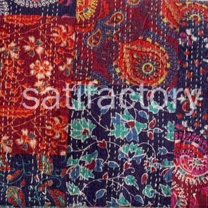 May include: A patchwork textile with a variety of patterns and colors. The design includes floral and paisley motifs in shades of red, blue, and purple. The word "satisfactory" is printed on the textile.