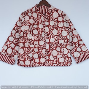 May include: A quilted jacket in a floral pattern. The jacket is primarily burgundy with a white floral design. The cuffs and collar are striped. The jacket is displayed on a wooden hanger.