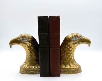 May include: A pair of brass eagle bookends holding two books titled "The Great Events by Famous Historians".