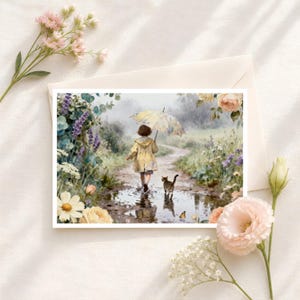 May include: A rectangular greeting card featuring an illustration of a child in a yellow raincoat holding a yellow umbrella, walking through a puddle on a dirt path with a tabby cat. The scene is surrounded by colorful wildflowers and greenery.