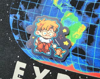 May include: A sticker featuring a cartoon character with orange hair, glasses, and red overalls holding a small brown animal. The sticker is on a blue and green world map background. The sticker has the text "saeuchalle".