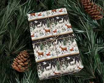 May include: Wrapped gift with a festive winter forest pattern featuring deer, foxes, and polar bears. The wrapping paper is tied with twine and set against a backdrop of pine needles and pine cones, creating a seasonal aesthetic.