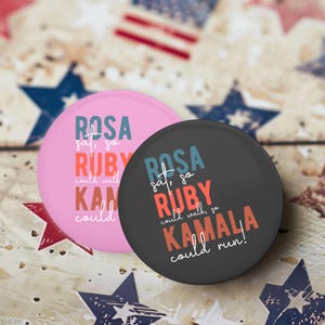 May include: Two round buttons with a black and white background. The text on the buttons reads "ROSA sat, so RUBY could walk, so KAMALA could run!"