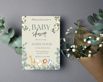 May include: Baby shower invitation featuring watercolor illustrations of safari animals and floral accents. The invitation includes the text "Please join us for a Baby Shower honoring Avery Davis". Eucalyptus and white flowers surround the invitation.