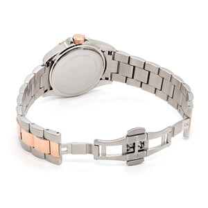 May include: A silver and rose gold tone watch with a stainless steel band. The watch has a round face and a silver dial. The band has a fold-over clasp.