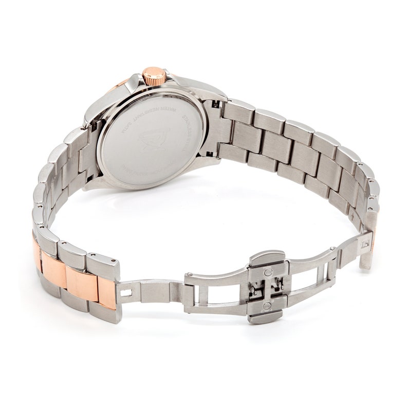 May include: A silver and rose gold tone watch with a stainless steel band. The watch has a round face and a silver dial. The band has a fold-over clasp.