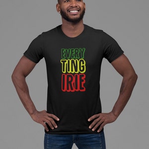 May include: A black t-shirt with the words "EVERYTHING IRIE" printed in green, yellow, and red.