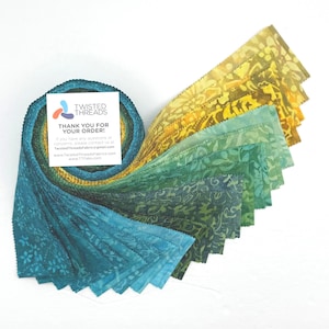 May include: A jelly roll of fabric strips featuring a gradient of colors from teal and dark green to yellow and gold. Each strip has a batik-style floral pattern. A square white card with the text TWISTED THREADS THANK YOU FOR YOUR ORDER is included.