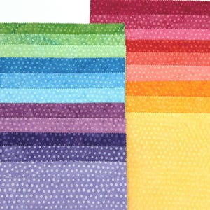 May include: A collection of fabric squares arranged in a gradient pattern, featuring a variety of colors including shades of green, blue, purple, yellow, orange, pink, and red. Each square has a consistent white polka dot pattern throughout.