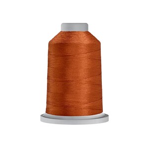 May include: A spool of orange-brown thread, tightly wound around a cylindrical core. The thread has a slight sheen, and the spool sits on a white base with a gray top. Ideal for sewing and embroidery projects.
