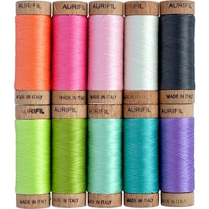 May include: Ten spools of Aurifil thread in various colors, including orange, pink, light pink, white, black, lime green, green, light green, turquoise, and purple. Each spool has a wooden label with the text "Aurifil" and "Made in Italy".