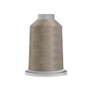 May include: A spool of light brown thread for sewing or embroidery.