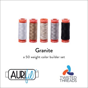 May include: A set of five spools of Aurifil 50 weight cotton thread in shades of light gray, tan, beige, dark gray, and black. Each spool features orange caps with the text Aurifil and 100% cotton. The text Granite a 50 weight color builder set is visible.