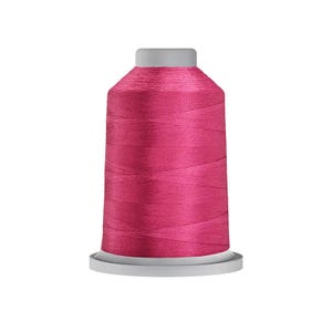 May include: A spool of vibrant magenta embroidery thread wound tightly around a cylindrical plastic core. The thread features a smooth, lustrous finish with visible diagonal winding patterns, set against a plain, neutral background.