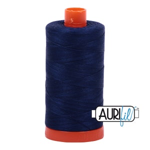 May include: A spool of dark blue thread with an orange plastic bobbin. The thread is labeled "Aurifil" in a white box with a blue border.