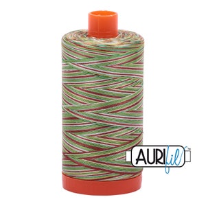 May include: A spool of Aurifil thread in a multi-colored pattern of green, red, and white stripes. The spool is orange and has the Aurifil logo on the side.