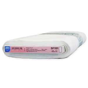 May include: A roll of white Pellon Shape-Flex SF101 fusible interfacing fabric. The label indicates 100% cotton, machine wash warm, tumble dry medium, and a width of 20 inches. The product is made in the USA and features a barcode and text.