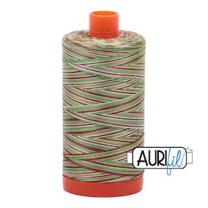 May include: A spool of variegated sewing thread featuring a repeating pattern of red, white, and green stripes wound around a cylindrical core with orange plastic caps at the top and bottom. The logo AURIfil is printed in black and blue on the side.