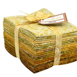 May include: A stack of 40 fat quarters of fabric in various shades of yellow, green, and brown. The fabric is patterned with a floral design and is tied together with a yellow ribbon. The label reads "Java Batik" and "40 Fat Quarters".
