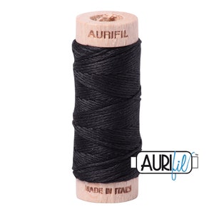 May include: A spool of black thread with a wooden bobbin. The bobbin is labeled "Aurifil" and "Made in Italy".