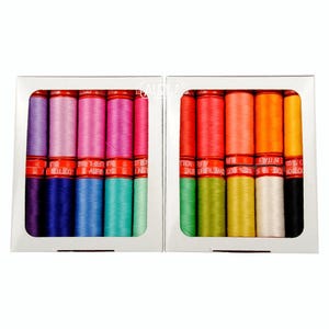 May include: Two white rectangular boxes containing a collection of Aurifil cotton thread spools. The left box holds purple, pink, and blue shades, while the right box features red, orange, yellow, green, white, and black spools in rows.
