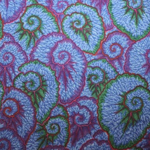 May include: A repeating pattern of stylized, swirling leaf shapes in shades of blue, purple, green, and red. The design features a textured appearance, with each leaf having a spiral center.