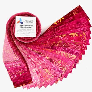 May include: A jelly roll of fabric strips in various shades of pink, magenta, and red, featuring batik-style patterns. A square white card is attached to the top, displaying the Twisted Threads logo and text, including contact information.
