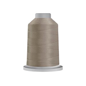 May include: A spool of light taupe sewing thread featuring a cylindrical shape with a flat top and a wider circular base. The thread is wound tightly around the central core, displaying a smooth, consistent texture and a neutral, earthy color tone.