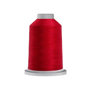 May include: A spool of bright red thread for sewing or embroidery.
