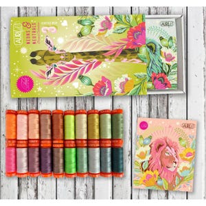 May include: A collection of Aurifil Neons & Neutrals cotton thread spools in various colors, presented in a decorative box featuring a giraffe illustration and a separate card with a lion illustration, both adorned with floral and botanical motifs.