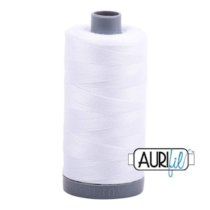 May include: A spool of white sewing thread with a grey plastic core. The spool features the brand name AuriFil embossed on the base and a logo with the text AuriFil printed in black and blue on the lower right side of the white thread surface.