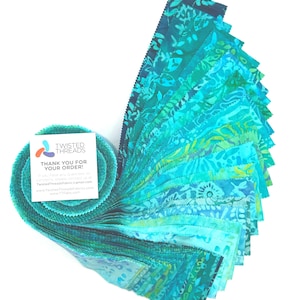 May include: A jelly roll of fabric strips in various shades of teal, turquoise, and blue with batik patterns. A white square card is attached to the roll, featuring the text TWISTED THREADS, THANK YOU FOR YOUR ORDER, and contact information.