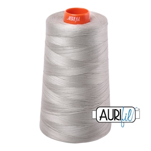 May include: A spool of silver gray thread with the brand name "Aurifil" printed on the spool and on a label attached to the side.