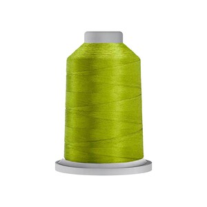 May include: A spool of vibrant lime green sewing thread wound tightly around a cylindrical core. The thread features a smooth, slightly reflective finish, and the spool is set on a flat, light gray circular base with a matching gray top cap.