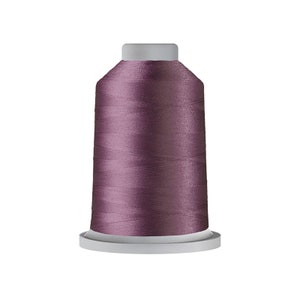 May include: A spool of mauve-colored thread for sewing or embroidery.