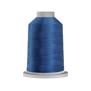 May include: A spool of deep blue sewing thread featuring a smooth, consistent texture wound tightly around a central core. The spool has a light gray plastic base and a matching light gray top cap, providing a clean, uniform appearance for the thread.