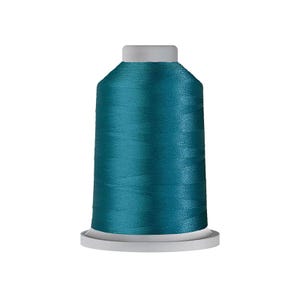 May include: A spool of teal embroidery thread featuring a smooth, lustrous finish. The thread is tightly wound around a cylindrical white plastic core with a flat base and a flat top, creating a uniform and consistent appearance for sewing projects.
