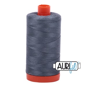 May include: A spool of gray thread with an orange plastic bobbin and the text "AURIfil" on the label.