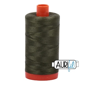 May include: A cylindrical spool of dark olive green sewing thread featuring a bright orange plastic top and bottom cap. The brand name AURIfil is printed in black and blue text on a white rectangular label attached to the side of the spool.