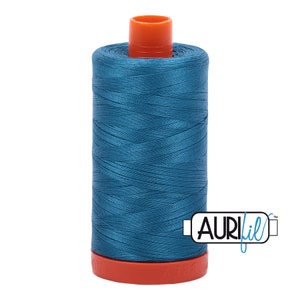 May include: A spool of teal blue thread with an orange plastic bobbin and the text "AURIfil™" on a white background.