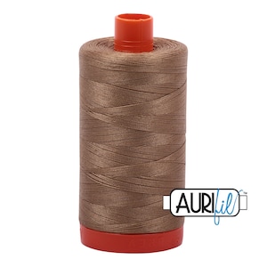 May include: A spool of brown Aurifil thread with a red plastic bobbin.