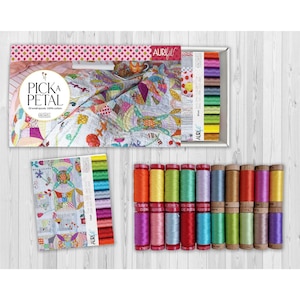 May include: A collection of Aurifil thread spools in various colors, arranged in rows. The image also features a box set with the text "PICK A PETAL" and a colorful quilt design, along with a booklet of thread color samples.