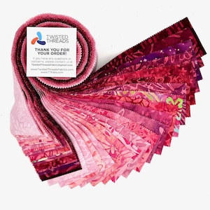 May include: A jelly roll of fabric strips in various shades of pink, magenta, and deep red, featuring diverse floral and abstract patterns with pinked edges. A square white card with the Twisted Threads logo and contact information is attached.
