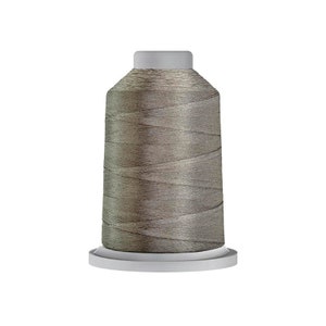 May include: A spool of gray embroidery thread on a white plastic bobbin.