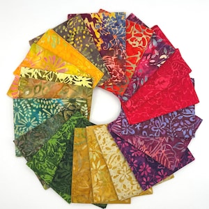 May include: A circular arrangement of rectangular fabric swatches featuring batik patterns in a full spectrum of colors including yellow, orange, red, pink, purple, blue, and green. Each piece displays distinct floral and leaf motifs in wax-resist.