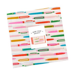 May include: A white fabric square patterned with colorful pen illustrations in pink, red, green, blue, and yellow. A white label with the text "RUBY STAR SOCIETY" and "TRINKETRY" is placed on top.