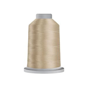 May include: A spool of beige thread for sewing or embroidery.