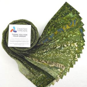 May include: A roll of green fabric strips with a variety of leaf and floral patterns. The fabric is fanned out to display the different designs. A white card with the text "TWISTED THREADS THANK YOU FOR YOUR ORDER!" is attached.