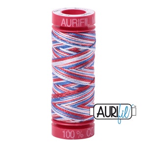 May include: A spool of red, white, and blue cotton thread with the Aurifil logo and "100% Cotton" text on the spool.